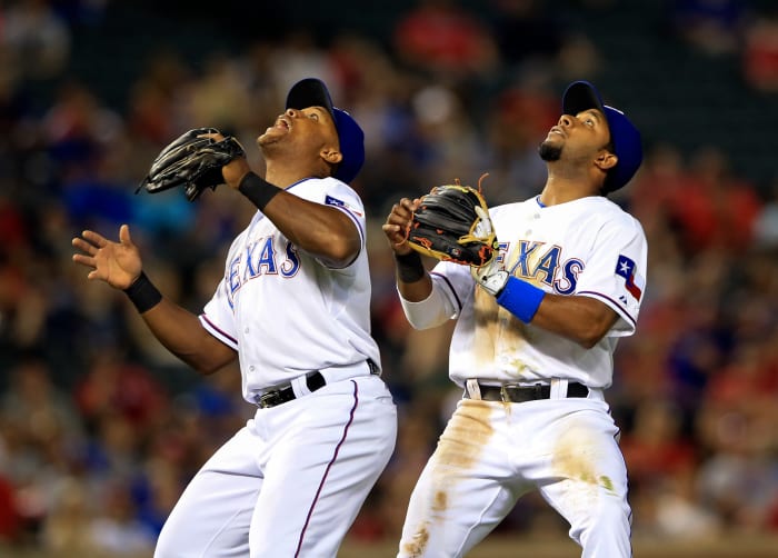 Texas Rangers third baseman Adrian Beltre left, and shortstop Elvis Andrus prepare for a fly ball during a game against the Oakland Athletics in May 2015 at Globe Life Park in Arlington.